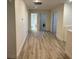 Hallway featuring light wood floors and neutral walls, connecting different areas of the home at 11074 Caramel Crest Ct, Las Vegas, NV 89135