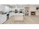 Stylish kitchen with white cabinets, stainless appliances, and a cozy fireplace at 11074 Caramel Crest Ct, Las Vegas, NV 89135