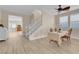 Open-concept living room with staircase, wood floors, and bright natural light at 11074 Caramel Crest Ct, Las Vegas, NV 89135