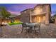 Backyard space featuring a covered patio, dining area, and a lawn with a slide for outdoor fun at 11274 Civita St, Las Vegas, NV 89141