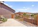 Balcony with comfortable seating, wrought iron railing, and views of the surrounding neighborhood at 11274 Civita St, Las Vegas, NV 89141