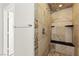 Close up of a shower with tiled walls, built-in shelves, and tile floor at 11274 Civita St, Las Vegas, NV 89141
