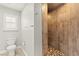 Elegant bathroom with tiled walk-in shower, toilet, and window for natural light at 11274 Civita St, Las Vegas, NV 89141
