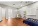 Bedroom with hardwood floors, ceiling fan, and a view to an ensuite bathroom at 11274 Civita St, Las Vegas, NV 89141