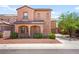 Two-story stucco house boasts a tile roof, arched entry, and a meticulously landscaped front yard at 11274 Civita St, Las Vegas, NV 89141