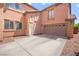 Exterior shot showcasing a large two-car garage with a wide driveway and a convenient side entrance at 11274 Civita St, Las Vegas, NV 89141
