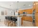 Bright kitchen with stainless steel appliances, a breakfast bar with seating, and ample wood cabinetry at 11274 Civita St, Las Vegas, NV 89141