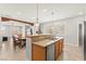 Eat-in kitchen island with stainless steel sink and stylish pendant lighting at 11274 Civita St, Las Vegas, NV 89141