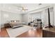 Spacious primary bedroom with a tray ceiling, hardwood floors, and large windows providing natural light at 11274 Civita St, Las Vegas, NV 89141
