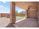 Covered patio with brick and concrete flooring, overlooking a grassy area with a play set at 11274 Civita St, Las Vegas, NV 89141