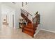 Beautiful wood staircase featuring decorative iron railings and natural light from nearby windows at 11274 Civita St, Las Vegas, NV 89141
