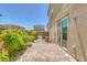 Enclosed backyard featuring brick pavers, greenery along the wall, and easy access via a sliding glass door at 1130 Blissful Plains Ave, North Las Vegas, NV 89086