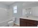 Well-lit bathroom includes tub, toilet, and vanity with modern fixtures and neutral color scheme at 1130 Blissful Plains Ave, North Las Vegas, NV 89086