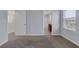 Comfortable bedroom with plush carpeting, neutral walls, and a view into an en-suite bathroom at 1130 Blissful Plains Ave, North Las Vegas, NV 89086