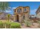 Exterior shot of the home highlighting the lush landscaping, arched entryway and earth tone stucco exterior at 1130 Blissful Plains Ave, North Las Vegas, NV 89086