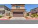 Attractive two-story home featuring a tile roof and desert landscaping at 1130 Blissful Plains Ave, North Las Vegas, NV 89086