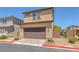 Charming two-story home with a brick-paved driveway and a tile roof at 1130 Blissful Plains Ave, North Las Vegas, NV 89086