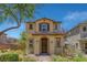 Charming two-story home featuring an arched entryway, brown shutters, and professionally landscaped front yard at 1130 Blissful Plains Ave, North Las Vegas, NV 89086
