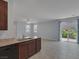Open living space with tile flooring, kitchen island, and sliding glass doors to the backyard at 1130 Blissful Plains Ave, North Las Vegas, NV 89086