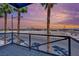 Balcony with palm trees and sunset sky at 1190 E Carson Ave, Las Vegas, NV 89101