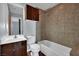 Well-appointed bathroom features a shower-tub combo, wood vanity and dark bronze fixtures at 1190 E Carson Ave, Las Vegas, NV 89101