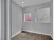 Modern bedroom features clean lines, light grey walls and wood look floors, plus lofted light area at 1190 E Carson Ave, Las Vegas, NV 89101