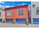 Striking modern townhome with colorful corrugated metal siding and blue garage doors at 1190 E Carson Ave, Las Vegas, NV 89101