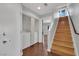 Convenient hallway setup with washer/dryer closet and wooden stairs leading to another level at 1190 E Carson Ave, Las Vegas, NV 89101