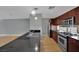 Modern kitchen featuring stainless steel appliances, dark countertops, and light wood flooring at 1190 E Carson Ave, Las Vegas, NV 89101