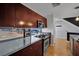 Modern kitchen features dark cabinetry, stainless steel appliances, and sleek countertops offering contemporary appeal at 1190 E Carson Ave, Las Vegas, NV 89101