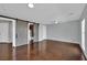 Spacious living room with stained floors, neutral paint and barn doors to ensuite bath at 1190 E Carson Ave, Las Vegas, NV 89101