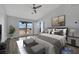 Staged main bedroom featuring vaulted ceilings, large windows and neutral paint at 1190 E Carson Ave, Las Vegas, NV 89101