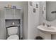 Powder room features a pedestal sink, toilet, and decorative wall decor at 1200 Mission View Ct, Henderson, NV 89002