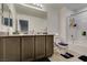 Bathroom featuring double sinks, neutral cabinets, and a shower-tub, providing functionality and comfort at 1200 Mission View Ct, Henderson, NV 89002