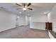 Spacious bonus room with gray carpet, ceiling fan, and adjacent laundry room for added convenience at 1200 Mission View Ct, Henderson, NV 89002