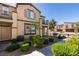 Desirable townhome showcasing manicured landscaping, a brick walkway, and charming architectural details at 1200 Mission View Ct, Henderson, NV 89002