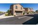 Townhomes featuring attached garages, desert landscaping, and well-maintained exteriors at 1200 Mission View Ct, Henderson, NV 89002
