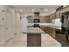 Bright kitchen with tile floor, granite counters, stainless appliances, and central island at 1200 Mission View Ct, Henderson, NV 89002