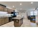 Open kitchen with granite counters, stainless appliances, and a view to an adjacent living area at 1200 Mission View Ct, Henderson, NV 89002