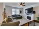 Bright living room featuring a fireplace, tile flooring and comfortable seating at 1200 Mission View Ct, Henderson, NV 89002