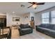 Living room with gray sofa and chairs, tile floors, and dining area at 1200 Mission View Ct, Henderson, NV 89002