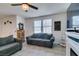 Comfortable living room with gray sofa, tile floors, and natural light at 1200 Mission View Ct, Henderson, NV 89002