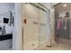 Shower with glass doors, built-in bench, and neutral tile, complemented by adjacent closet space at 1200 Mission View Ct, Henderson, NV 89002