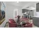 Chic dining area with a glass-top table, stylish chairs, and an open view to the modern kitchen at 1390 Vegas Valley Dr # 26, Las Vegas, NV 89169