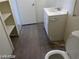 Simple bathroom features a vanity sink, toilet, and storage shelves at 1405 Vegas Valley Dr # 360, Las Vegas, NV 89169