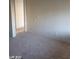 A carpeted bedroom with neutral paint, an opening to the next room, and natural light from a side window at 1405 Vegas Valley Dr # 360, Las Vegas, NV 89169