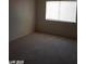 A carpeted bedroom with neutral walls and a window offers a versatile and comfortable living space at 1405 Vegas Valley Dr # 360, Las Vegas, NV 89169