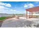 Large backyard patio with a pergola, built in fire pit with seating, and desert landscaping provides outdoor entertaining at 1611 Buffalo Trail Dr, Henderson, NV 89014