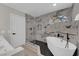 Modern bathroom featuring a soaking tub, glass shower, and marble-look tile at 1611 Buffalo Trail Dr, Henderson, NV 89014