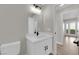 Bathroom featuring white vanity with dark hardware, wall mirror, and toilet at 1611 Buffalo Trail Dr, Henderson, NV 89014